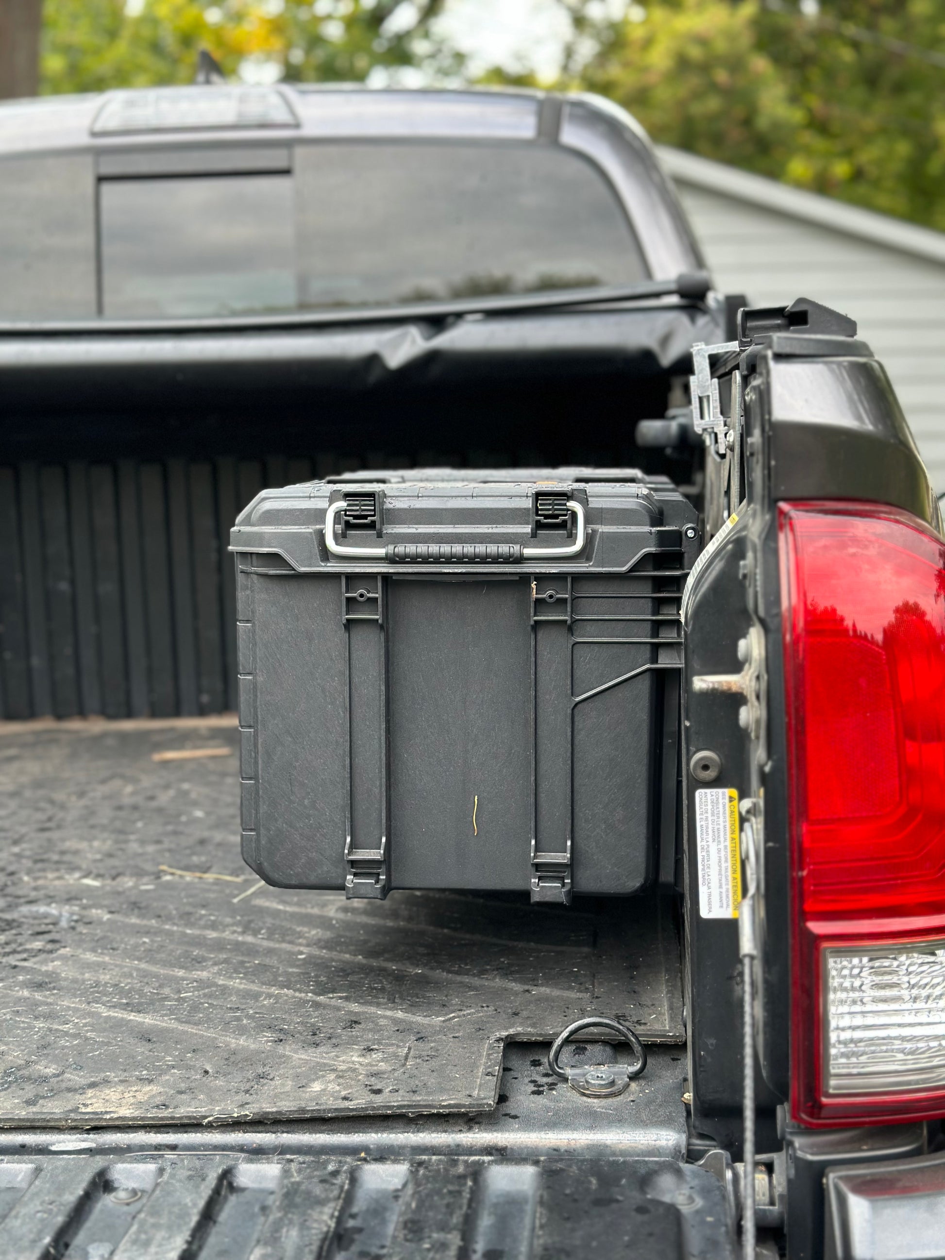 Area 15 Designs Rigid Pro Gear 22in Toolbox Bracket mounted on Toyota Tacoma bed rail system, showing secure fit and clean, organized installation. Taillight view